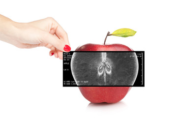 Female doctor holding an x-ray revealing inner view of a red app