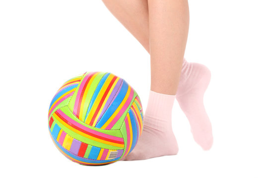 Human legs with a multicolored ball