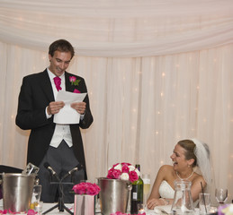 Attractive young bride grimaces at groom's speech