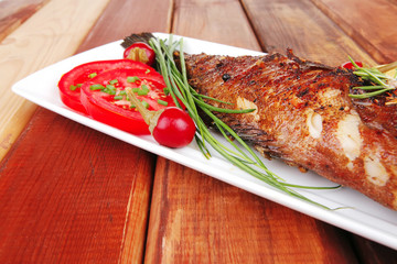 served main course on wood: fried seabass