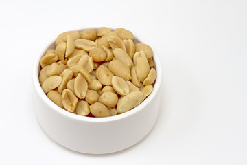 Small white bowl of salted peanuts