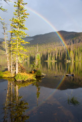 Rainbow over wilderness lake
