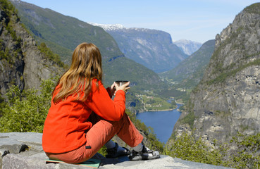 girl hiker looking at the fjord