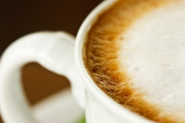 Closeup photo of latte coffee cup