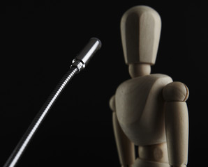 Wooden dool figure speaks into microphone