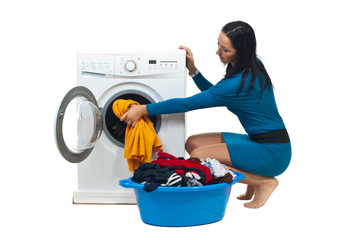 Housewife loading washing machine