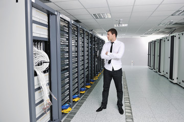 young engeneer in datacenter server room