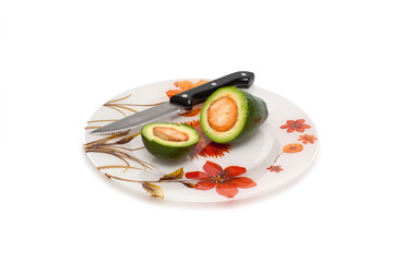 avocado plate with a knife on a white background