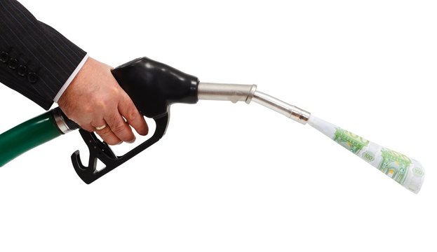 Money pouring from gas nozzle