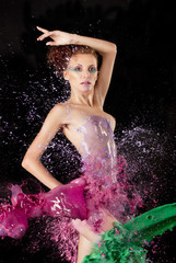 Naklejka premium Naked body with Colored water splashing over it
