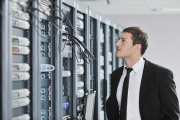 young engeneer in datacenter server room