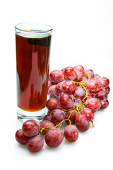 Grape cluster and juice in glass..