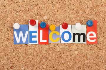 The word Welcome in magazine letters on a notice board