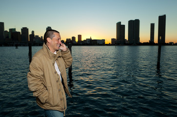 Handsome Hispanic man in a lifestyle pose with a mobile phone