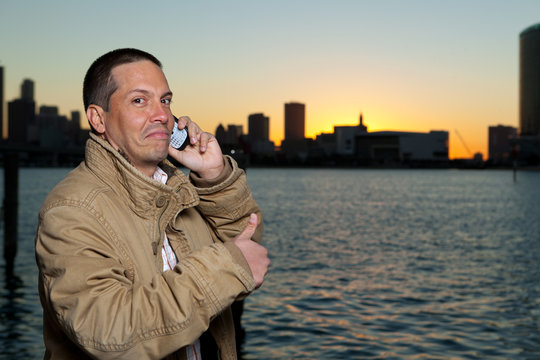 Handsome Hispanic man in a lifestyle pose with a mobile phone
