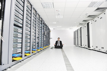 business man practice yoga at network server room