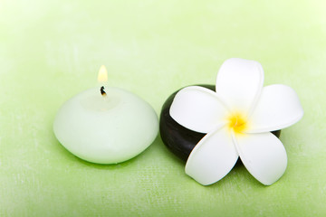 Fototapeta na wymiar Candle, spa stone and frangipani flower