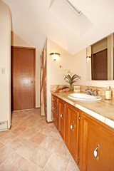 Bathroom with wood cabinets and door