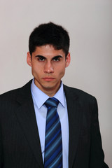 Young man. On gray background.