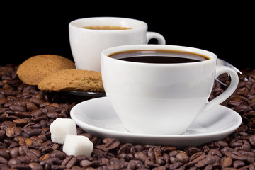 cup of coffee and cookies on beans