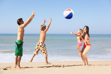Young family play on beach