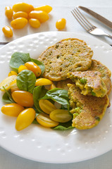 Homemade chickpea flour pancakes with fresh yellow tomatoes