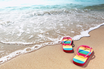 Flipflops on a sandy ocean beach