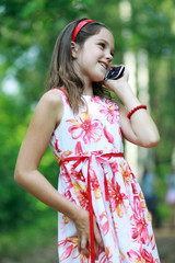 Little girl talks by mobile phone