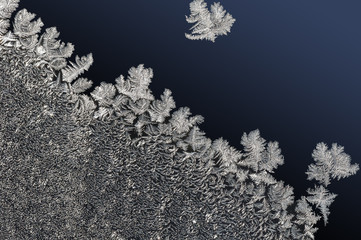 winter background frozen water crystals on gradual dark blue