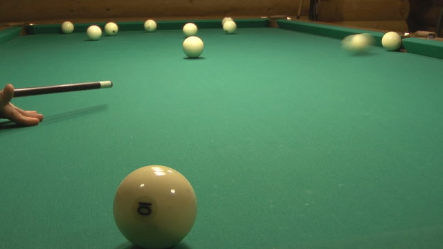 Billiard ball falls into the central pocket.
