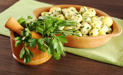 Herbs in mortar (parsley, rosemary) with potatoes