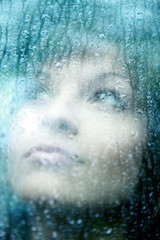 Sad young woman and a rain drops
