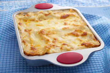 classic lasagna over blue cloth