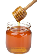 honey pouring in jar isolated