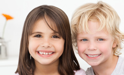 Adorable brother and sister posing in the kitchen