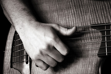 playing six-string electric bass guitar; slap technique