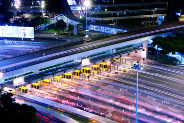 blurred bus light trails in downtown night-scape