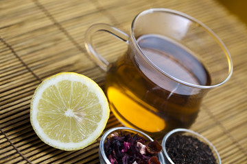 Glass cup of tea with lemon