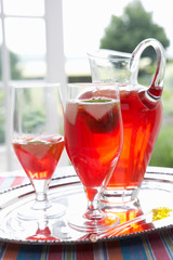 Fruit drink in a decanter and glasses