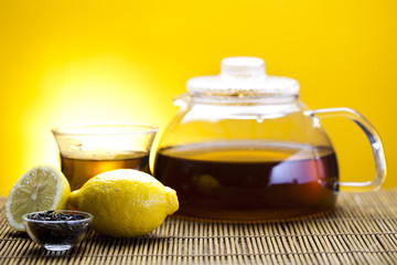 Glass teapot and cup with green tea