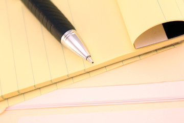 note pad with pen and folder