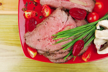 hot ham on red dish over wooden table