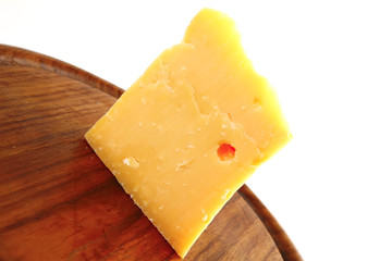 solid gauda cheese on wood