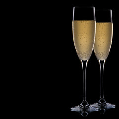 A glass of champagne, isolated on a black background.