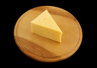 Cheese on wooden board isolated