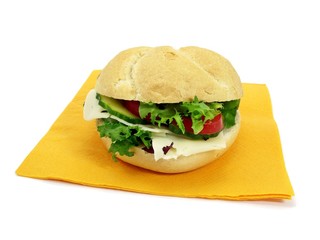 A cheese salad bread roll on a paper napkin