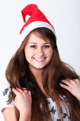 beautiful young girl with red christmas hat