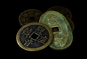 Obraz na płótnie Canvas Chinese coins on black