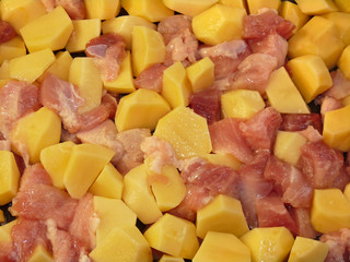 Meat and potatoes in trays, isolated on a white background