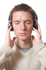 young man listening music with headphone isolated